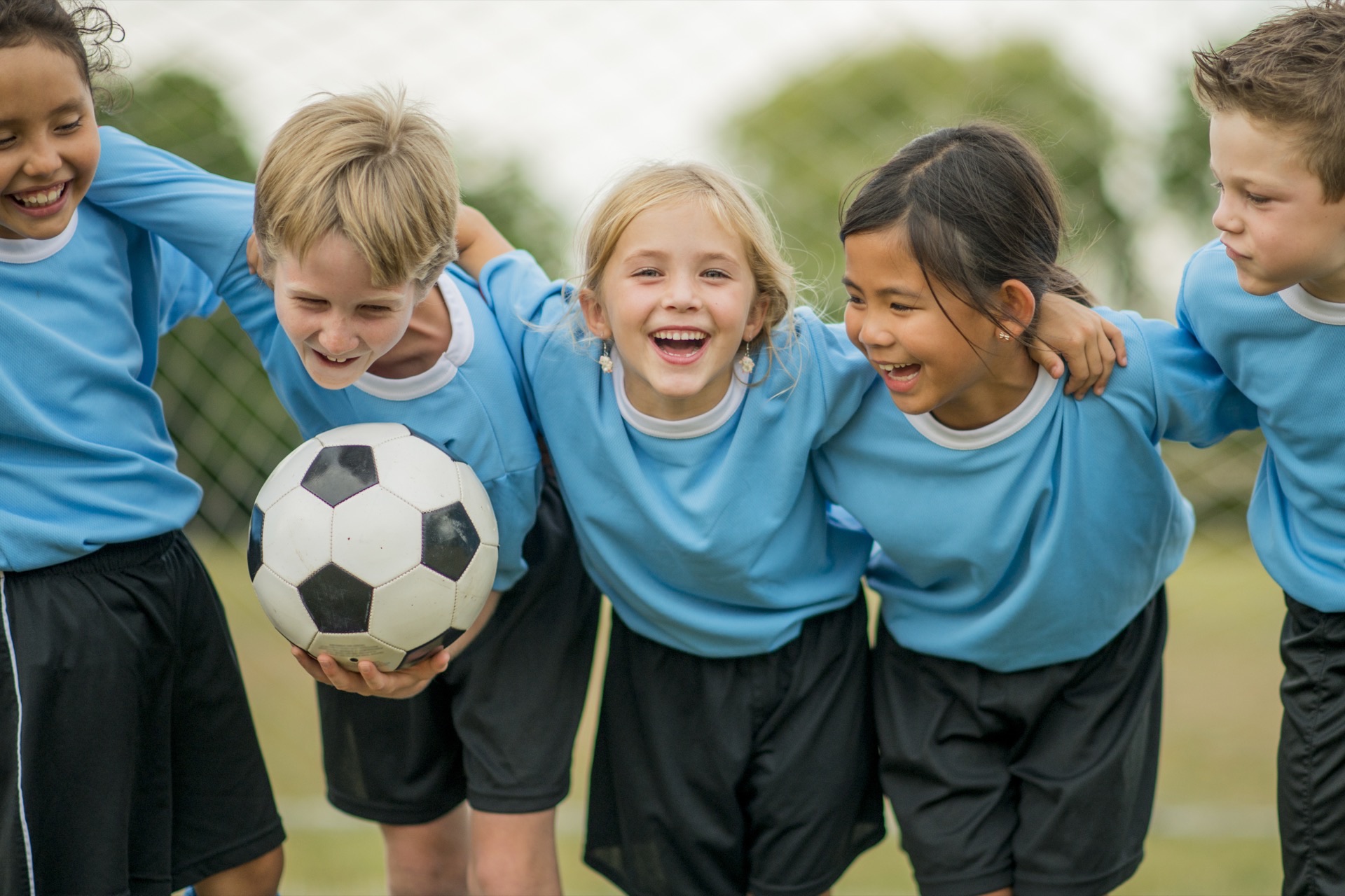 Youth soccer team celebrating together